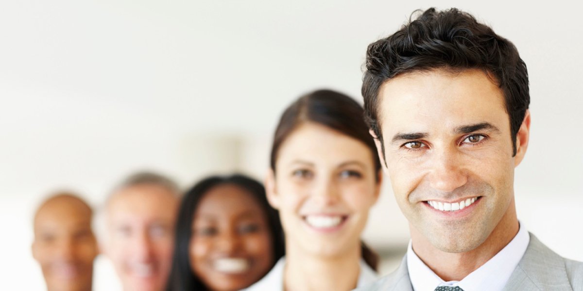 A diverse group of business professionals smiling together in a meeting