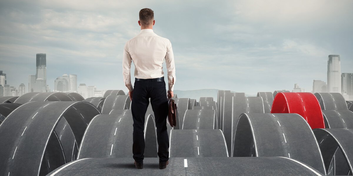 A man on a road with a red arrow pointing ahead