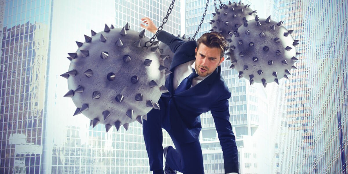 A man in a suit dangles from a rope