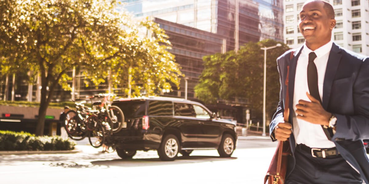 A businessman in a suit and tie walking confidently on a city street