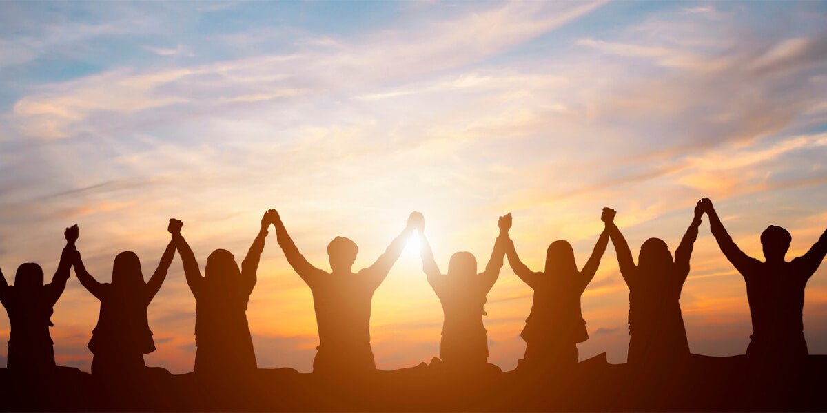 Group of people with hands raised