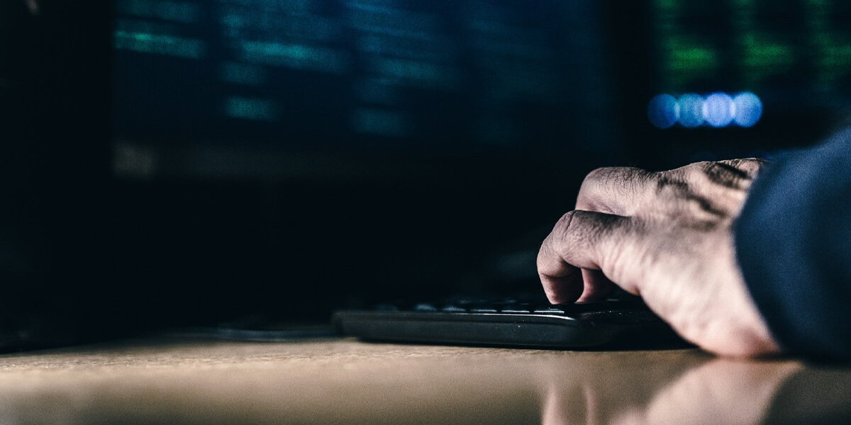 A person typing on a computer keyboard