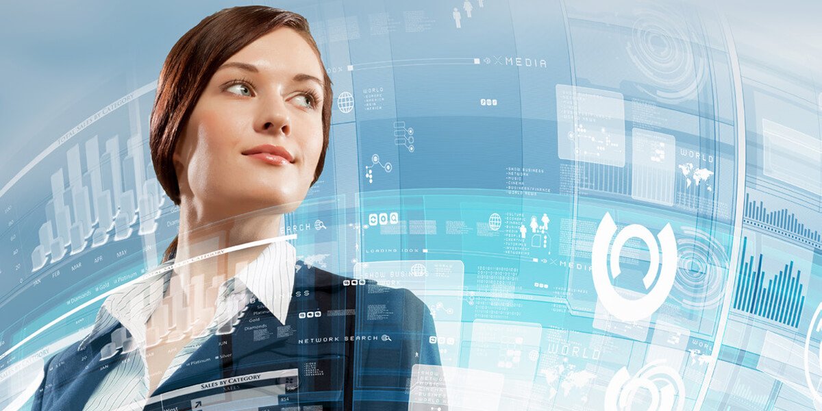 Woman in business attire looks up at digital display
